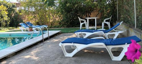 a group of chairs sitting next to a swimming pool at Marina in Lleida