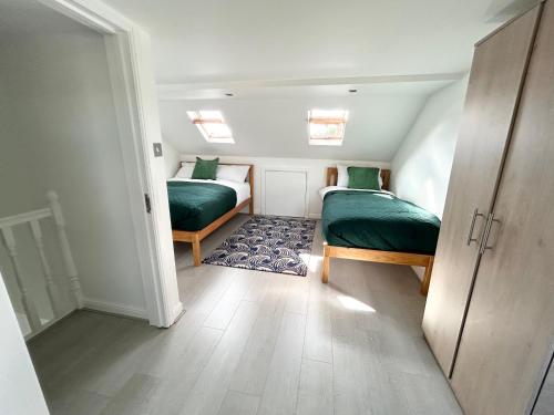 a small room with two beds and a hallway at London Serviced Accommodation near Tottenham Hotspurs Football Stadium Great for Contractors in London