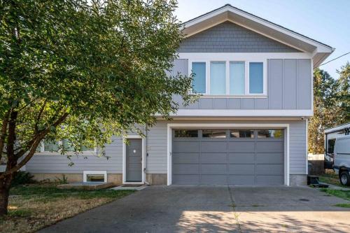 a white house with a garage at NEW! - Bright Modern Entire Unit KING BED! in Portland