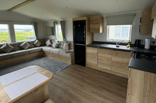 a kitchen and living room of a caravan at Sea La Vie Caravan at Silver Sands Holiday Park in Lossiemouth