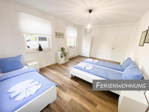 a bedroom with two beds and a couch at Hotel Zur Linde in Zschepplin