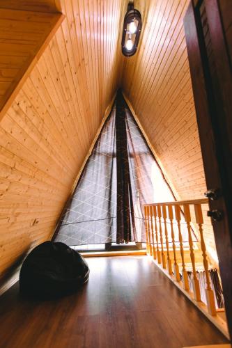 a room with a large window in a attic at Cottage Sataplia in Kutaisi