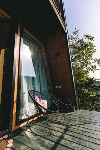 two chairs sitting on the porch of a house at Cottage Sataplia in Kutaisi