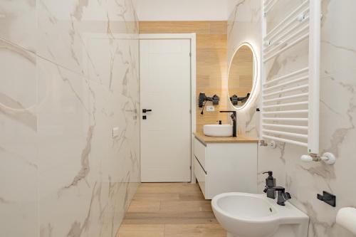 a bathroom with a white sink and a mirror at Appartamento Visconti by Rhospitality it in Rho