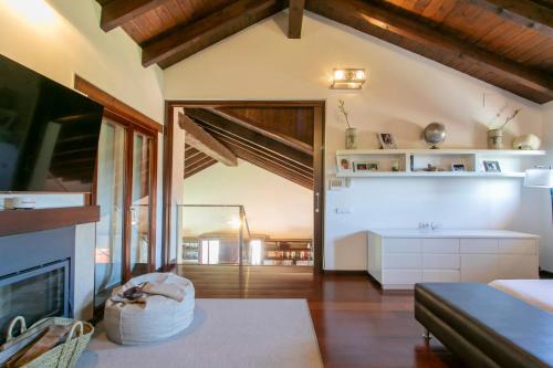 a living room with a fireplace and a couch at La Traviesa,Villa de Lujo de 500 m. en el Campo con Piscina in Campo Arcís