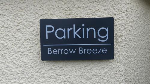 a sign on a wall that reads parking behaviour freeze at Berrow Breeze in Burnham on Sea