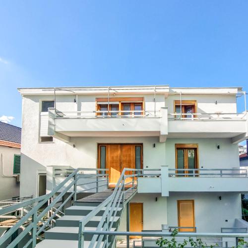 a white building with stairs in front of it at Villa 27 Residence in Tirana