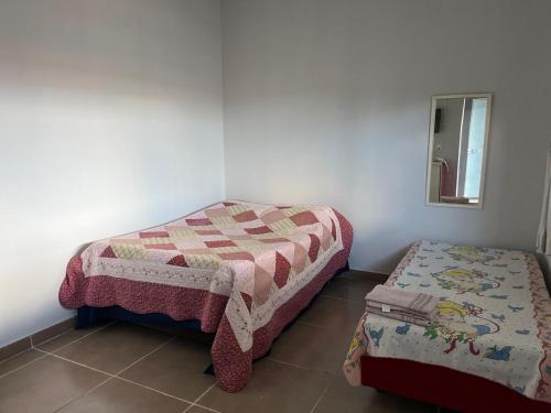Ένα ή περισσότερα κρεβάτια σε δωμάτιο στο Residencial Jasmim Casa 01