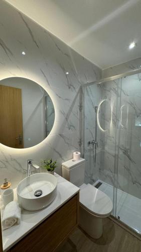 a bathroom with a sink and a toilet and a shower at Refúgio do Espigueiro in Amarante