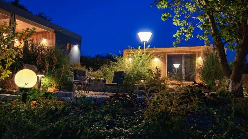 a garden at night with lights on a house at Casa Slarku - Luxury Container Houses in Miskolc