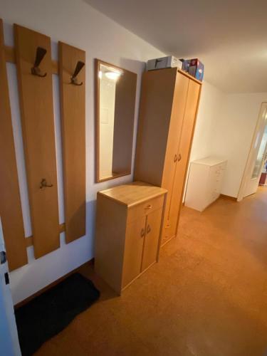 a room with wooden cabinets and a mirror at Park und Therme in Bad Wildbad