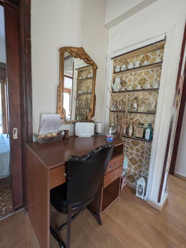 a desk with a mirror and a chair in a room at Μπαλκόνι του Αιγαίου/ Aegean balcony in Tsagarada