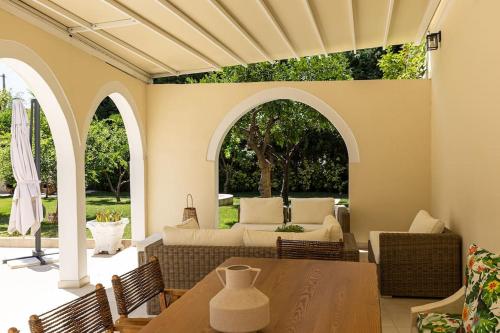 a patio with a table and chairs and a couch at Molos Residence in Mólos