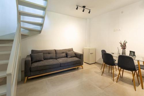 a living room with a couch and a table at Molos Residence in Mólos