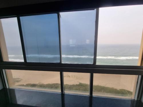 a view of the beach from a window at 2102 Amanzi in Amanzimtoti