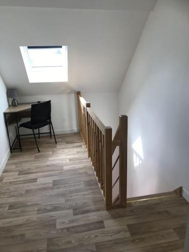 a hallway with stairs and a desk in a room at L'Impasse Maison avec Jardin in Isbergues