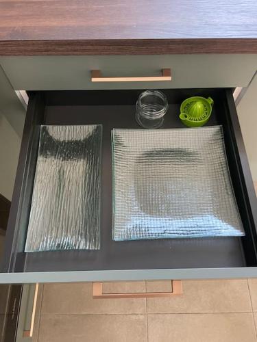 a drawer in a cabinet with some nets and plates at L'Impasse Maison avec Jardin in Isbergues