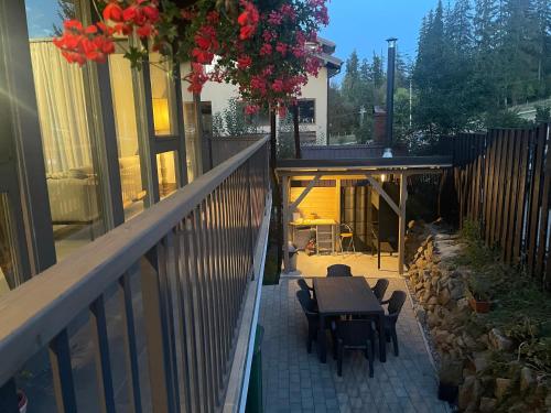 a balcony of a house with a table and chairs at REY Chalet in Vatra Dornei