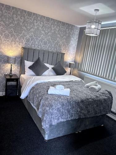 a bedroom with a bed with two towels on it at Luxury Home in Luton - Near L&D Hospital - FREE Netflix & Wifi- FREE Parking in Lewsey