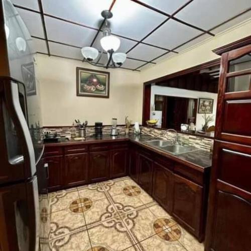 a kitchen with wooden cabinets and a counter top at Aurora Retreat Costa Rica in Tilarán