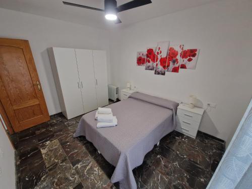 een slaapkamer met een bed en een plafondventilator bij Marfil 6 in Salobreña