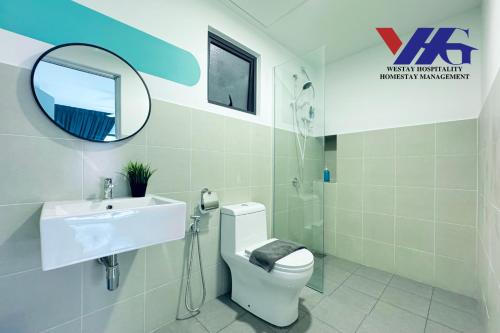 a bathroom with a toilet and a sink and a mirror at Arena Residence Sepang KLIA With Netflix by Westay Hospitality in Kampong Melot
