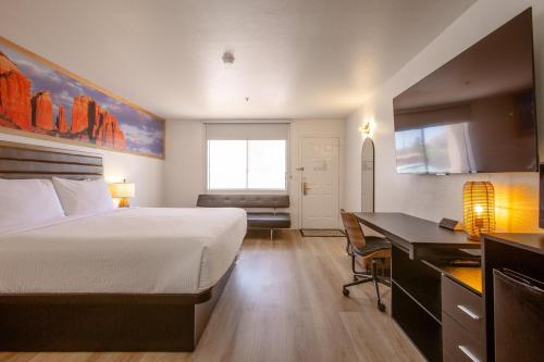a hotel room with a bed and a desk and a kitchen at GreenTree Inn Sedona in Sedona