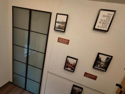 a wall with pictures on a wall with a door at Chalet Wahida- Wellness Oase im Neckertal! in Sankt Peterzell