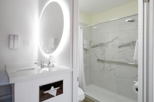 a white bathroom with a sink and a shower at GreenTree Inn Sedona in Sedona