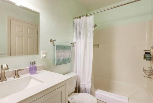 a white bathroom with a sink and a shower at Cheyenne Chalet - Perfect little rancher in SLT! in Mevers
