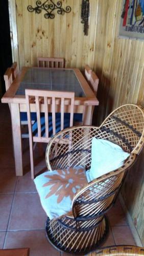 a room with a table and a chair and a table and a table and chairs at Iloca Cabaña Rancura in Iloca