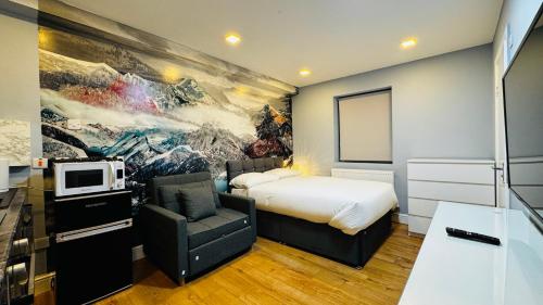 a bedroom with a bed and a couch and a tv at Private Boutique Apartments London in London