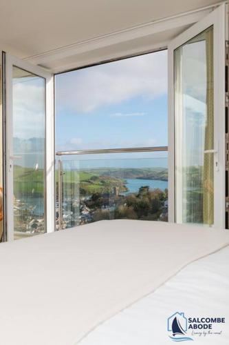 a room with a large window with a view at Ultimate Coastal Escape - Stylish & Estuary Views in Salcombe