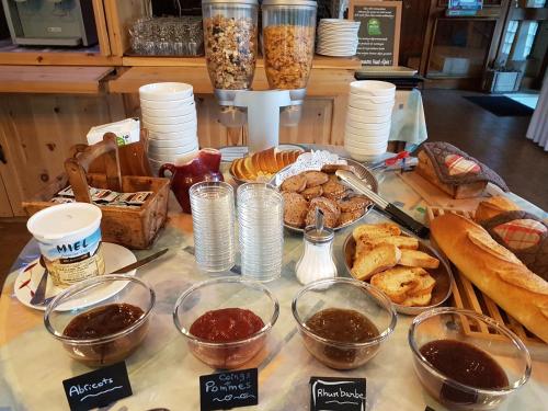 a table topped with lots of different types of bread at Hotel Le Chamois Logis in Molines-en-Queyras