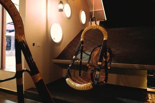 a rattan purse hanging from a table in a room at Luxurious 5000 SQFT Mansion with Modern Comforts And Spacious Elegance in Malappuram