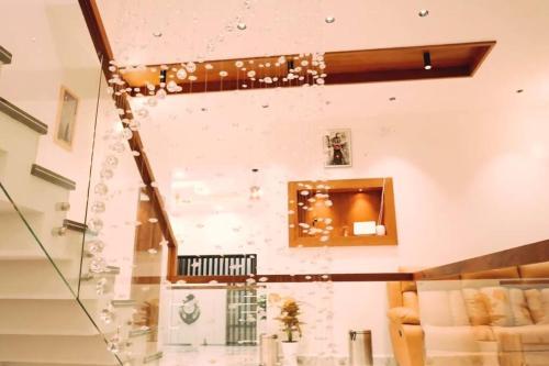 a staircase in a living room with bubbles at Luxurious 5000 SQFT Mansion with Modern Comforts And Spacious Elegance in Malappuram