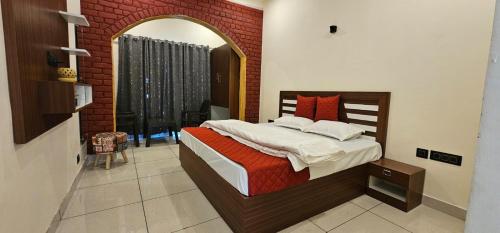 a bedroom with a large bed with a mirror at Golden Himalaya Homestay in Kausani
