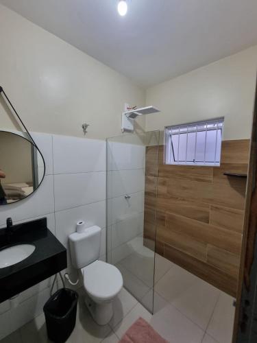 a bathroom with a toilet and a sink and a shower at Hotel Itatiaia in Tangara da Serra