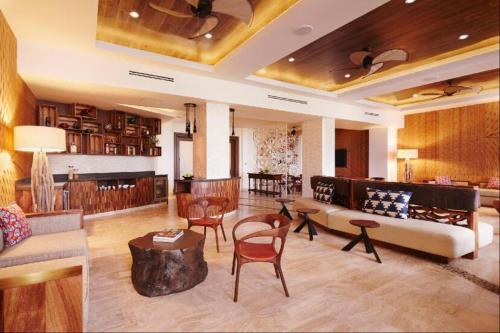 a living room with a couch and chairs and a table at Beach&Golf suites in El Bedito