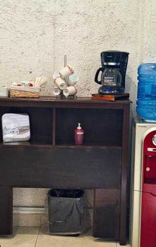 a table with a coffee maker on top of it at Hotel del Capitán de Puebla in Puebla
