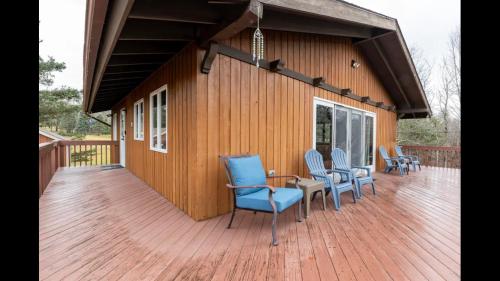 a deck with chairs and a table on a building at Beautiful Windham Chalet 2 minutes to the Mountain in Windham