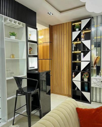 a living room with a table and a wine cellar at 1 bedroom, 24hrs light, Netflix, Swimming pool in MIJL, Salem, Ikate in Lagos