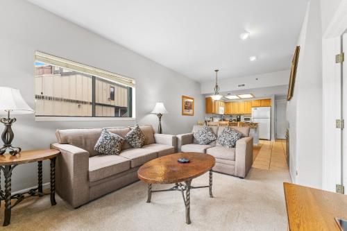 a living room with a couch and a table at Greens at Copper 219 in Copper Mountain