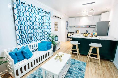 a living room with a couch and a kitchen at Balikbayan hub in Cabanatuan in Cabanatuan
