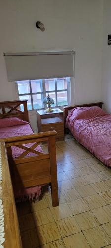 En eller flere senge i et værelse på Departamento RyJ