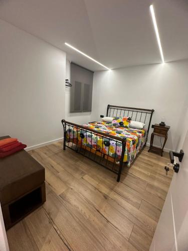 a bedroom with a bed and a wooden floor at Vidanova 1 in Vilanova i la Geltrú