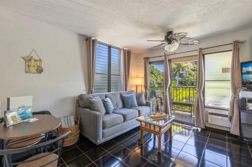 a living room with a couch and a table at Kihei Akahi C320- Kihei Studio, walk to shops, dining, & the beach in Wailea