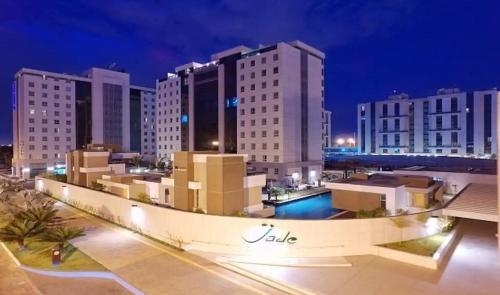 a view of a city at night with buildings at JADE - Flat Particular in Brasilia