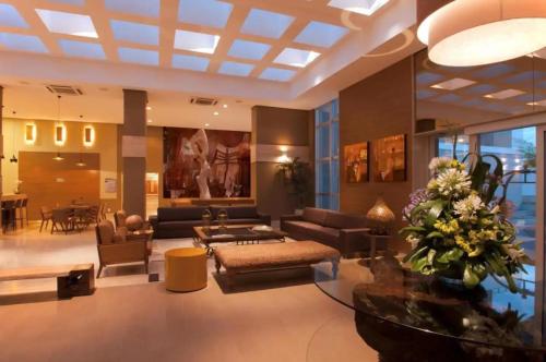 a living room with a couch and a table at JADE - Flat Particular in Brasilia