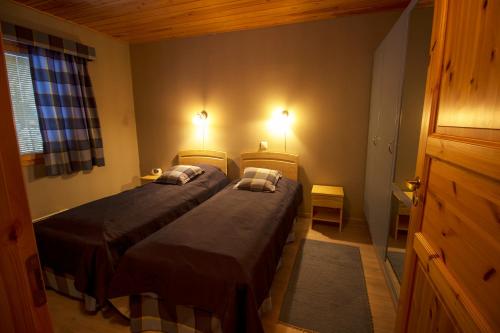 A bed or beds in a room at Polar Star Origo Apartments